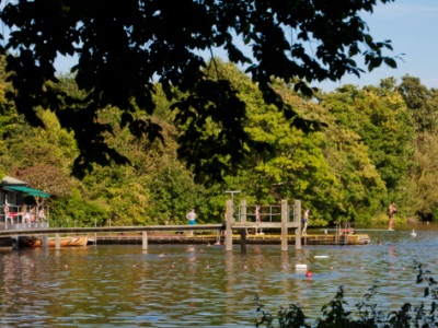 man in pink shirt with brown belt